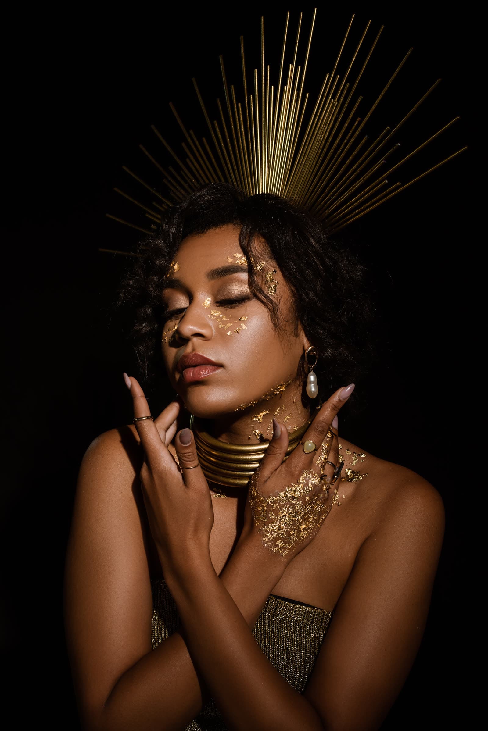A woman adorned in gold jewellery and makeup